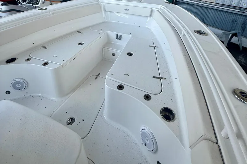 Slide: The Image of 2023 Sea Hunt Ultra 265 SE boat interior with storage compartments and speakers. - 14