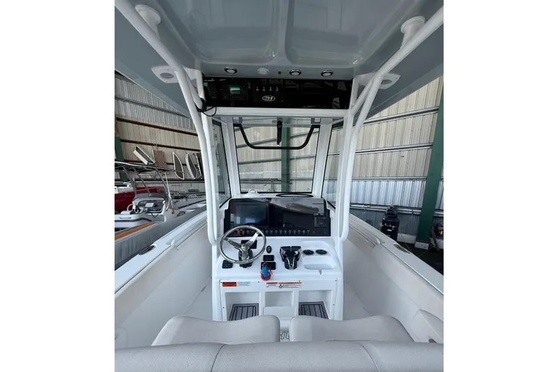 Slide: The Image of 2023 Sea Hunt Ultra 265 SE boat cockpit with steering wheel and controls. - 15