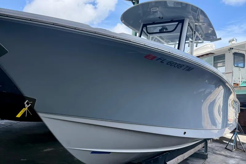 Slide: The Image of 2023 Sea Hunt Ultra 265 SE boat docked, showcasing sleek design and modern features. - 2