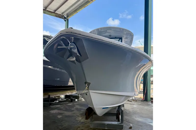 Slide: The Image of 2023 Sea Hunt Ultra 265 SE boat in a covered storage area. - 3