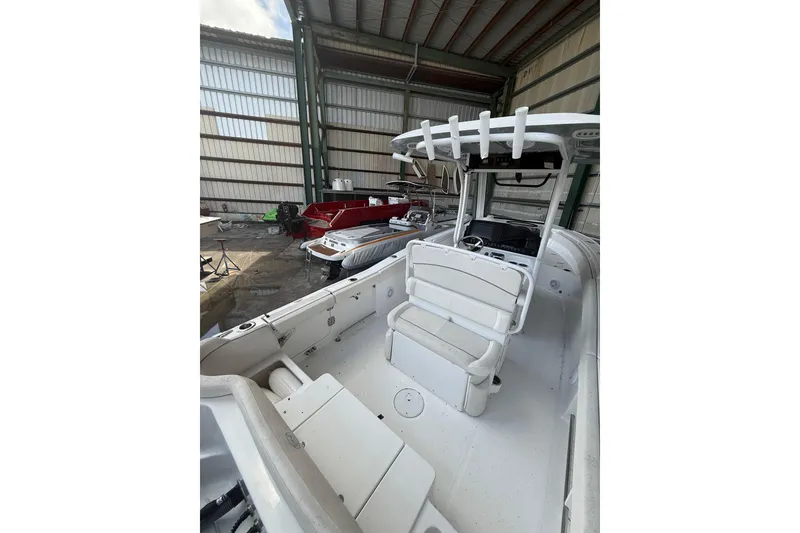 Slide: The Image of 2023 Sea Hunt Ultra 265 SE boat interior in a storage facility. - 4