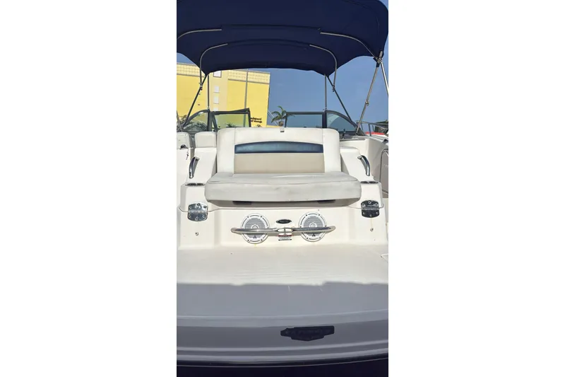 Slide: The Image of 2013 Chaparral Sunesta 224 boat with seating and canopy, docked under clear sky. - 10