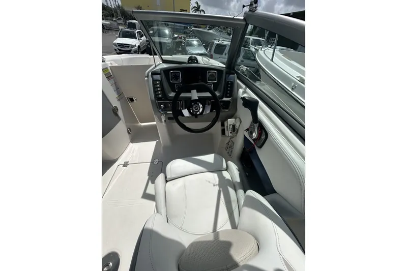 Slide: The Image of 2013 Chaparral Sunesta 224 boat interior with steering wheel and dashboard controls. - 5