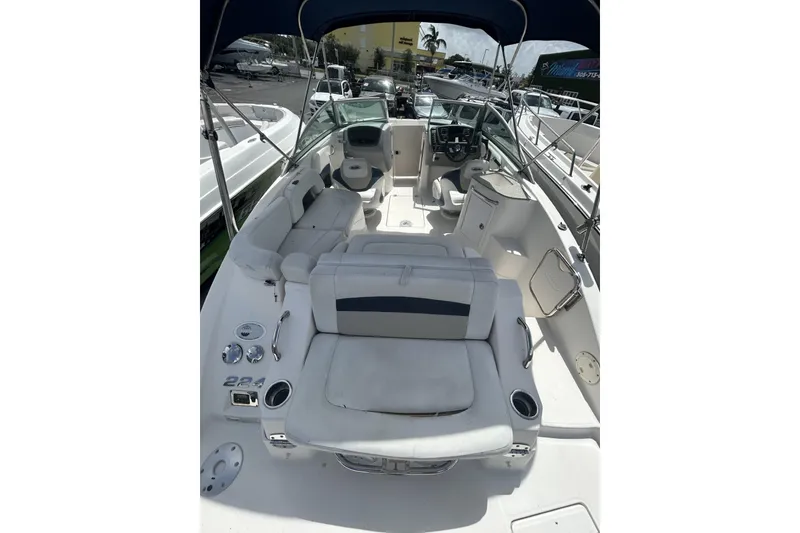 Slide: The Image of 2013 Chaparral Sunesta 224 boat interior with seating and steering wheel. - 7