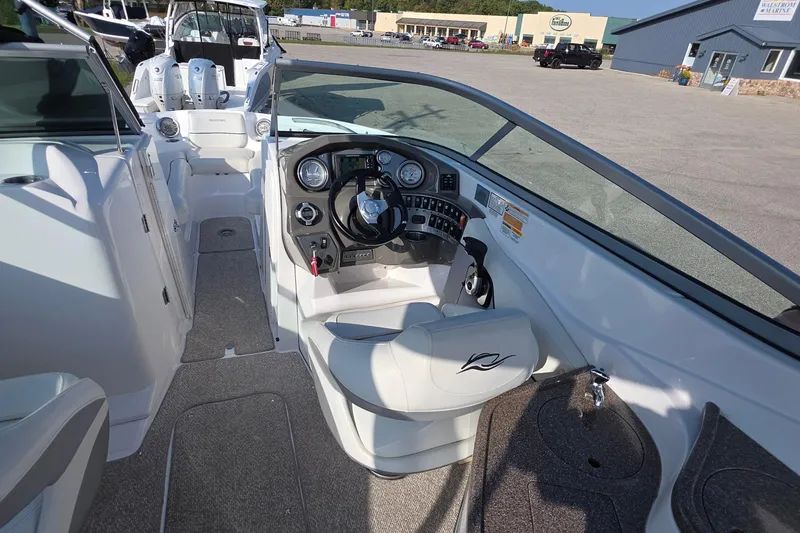 Slide: The Image of 2013 Rinker 276 Captina boat interior with steering wheel and dashboard controls. - 15