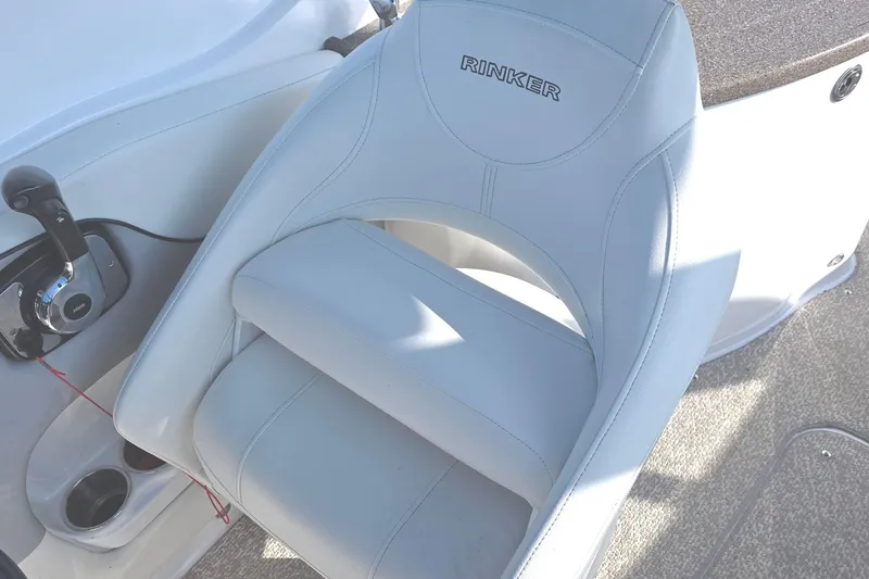 Slide: The Image of Captain's seat on 2013 Rinker 276 Captina boat, featuring sleek design and controls. - 23