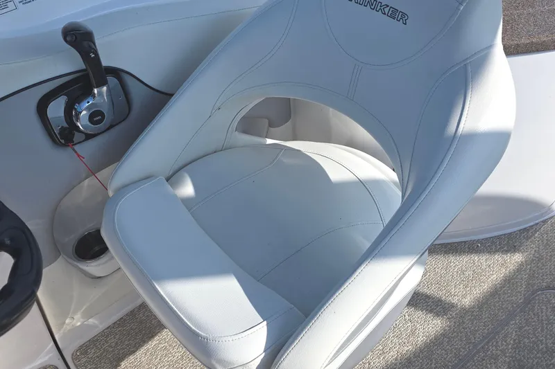 Slide: The Image of Captain's seat and controls of 2013 Rinker 276 Captina boat. - 24