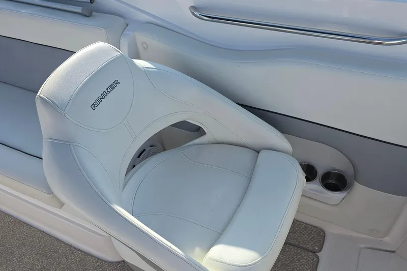 Slide: The Image of White leather seat on 2013 Rinker 276 Captina boat, featuring cup holders and sleek design. - 26