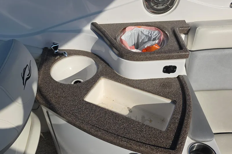 Slide: The Image of 2013 Rinker 276 Captina boat interior with sink and trash compartment. - 28