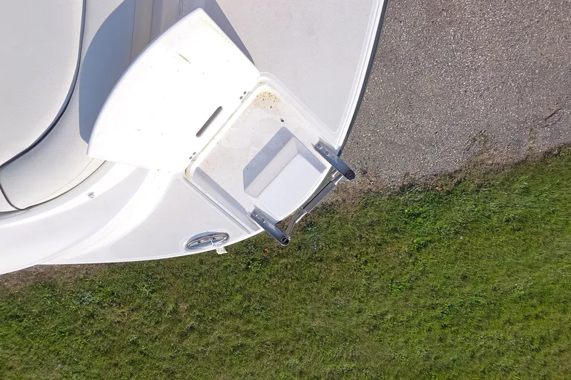 Slide: The Image of 2013 Rinker 276 Captina boat ladder on grassy surface. - 36