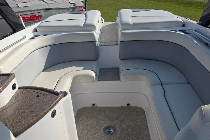 Slide: The Image of 2013 Rinker 276 Captina boat interior with cushioned seating and carpeted flooring. - 40