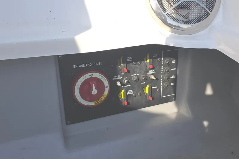 Slide: The Image of Control panel of a 2013 Rinker 276 Captina boat, featuring engine and house switches. - 41