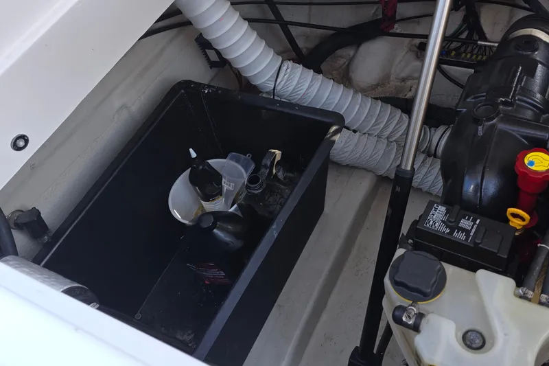 Slide: The Image of Engine compartment of 2013 Rinker 276 Captina boat with maintenance supplies. - 46