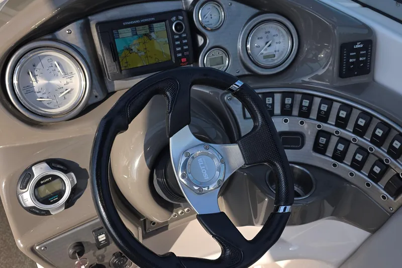 Slide: The Image of Dashboard of 2013 Rinker 276 Captina boat with steering wheel and navigation instruments. - 8