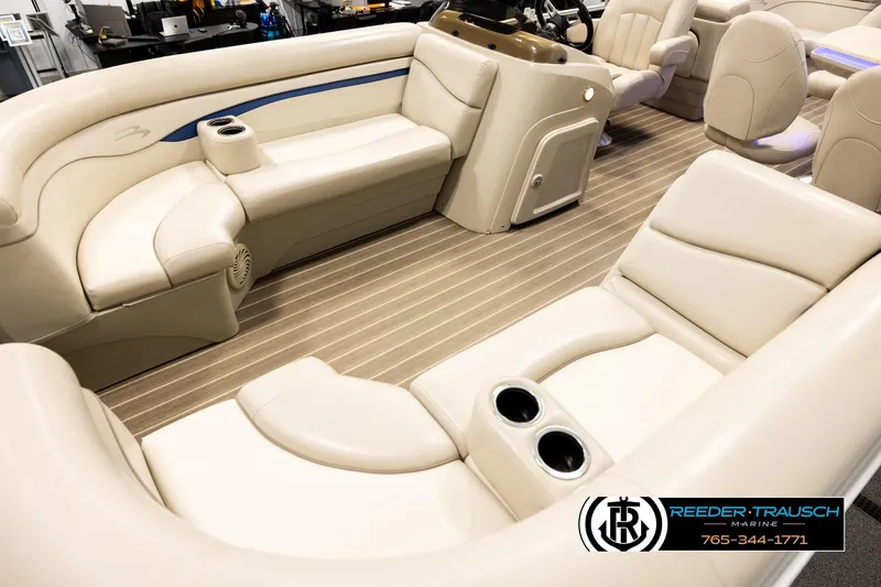 Slide: The Image of 2016 Bennington 24 SPDXDF boat interior with beige seating and wood-style flooring. - 10
