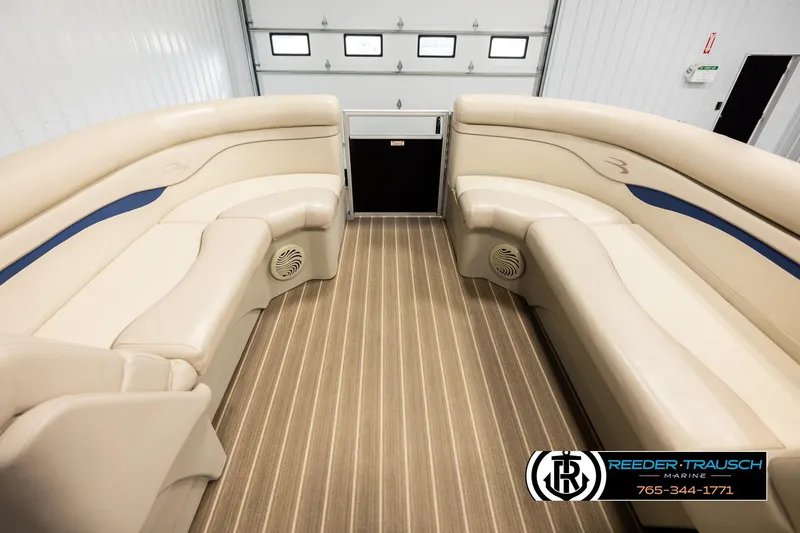 Slide: The Image of 2016 Bennington 24 SPDXDF boat interior with beige seating and striped flooring. - 18
