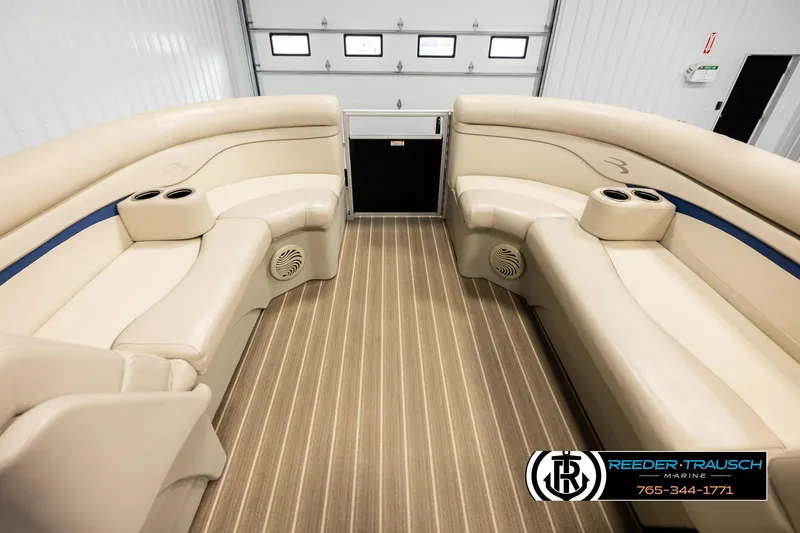 Slide: The Image of Interior of a 2016 Bennington 24 SPDXDF pontoon boat with beige seating and cup holders. - 19