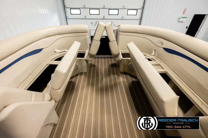 Slide: The Image of 2016 Bennington 24 SPDXDF boat interior with beige seating and striped flooring. - 20
