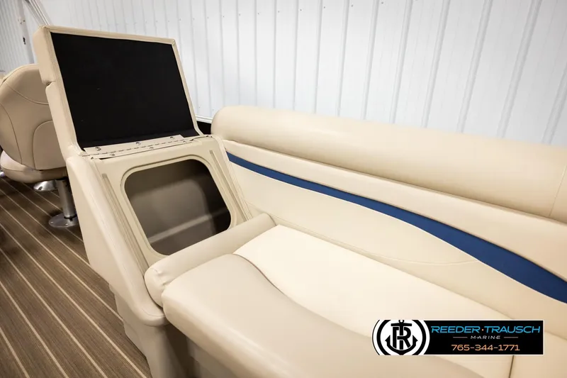 Slide: The Image of 2016 Bennington 24 SPDXDF boat interior with beige seating and storage compartment. - 22