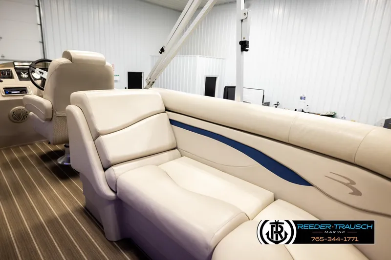 Slide: The Image of 2016 Bennington 24 SPDXDF boat interior with beige seating and steering wheel. - 25
