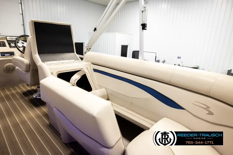 Slide: The Image of 2016 Bennington 24 SPDXDF boat interior with beige seating and blue accent. - 26