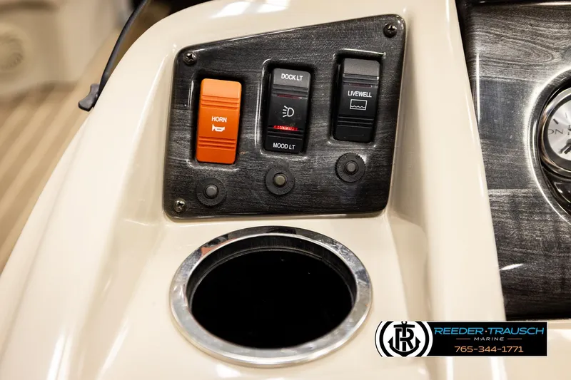 Slide: The Image of Control panel of a 2016 Bennington 24 SPDXDF boat with switches and cup holder. - 33