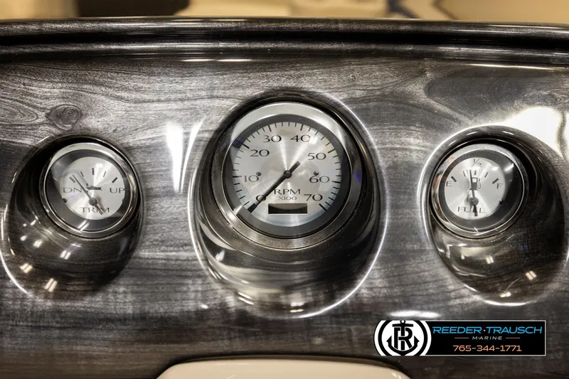 Slide: The Image of Dashboard of a 2016 Bennington 24 SPDXDF boat with gauges and Reeder-Trausch Marine logo. - 34