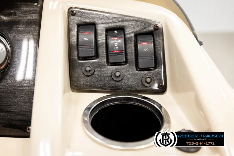 Slide: The Image of Control panel of 2016 Bennington 24 SPDXDF boat with switches and cup holder. - 36