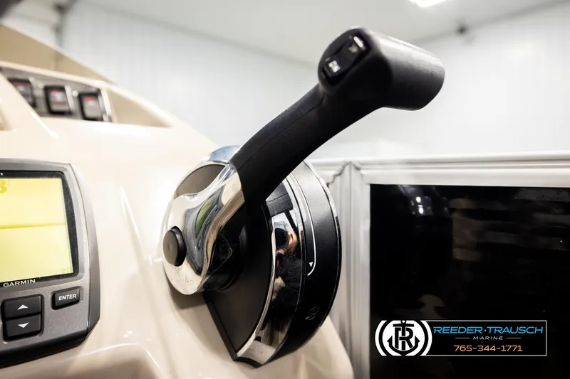 Slide: The Image of Close-up of a 2016 Bennington 24 SPDXDF boat throttle and Garmin display. - 38