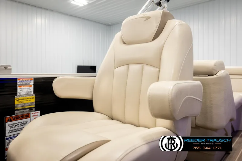 Slide: The Image of Luxurious beige seating on 2016 Bennington 24 SPDXDF boat, featuring armrests and warning labels. - 39