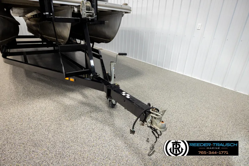 Slide: The Image of 2016 Bennington 24 SPDXDF pontoon trailer in a showroom with Reeder-Trausch Marine logo. - 52