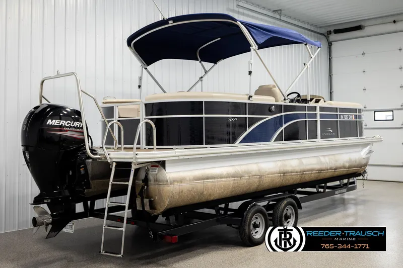 Slide: The Image of 2016 Bennington 24 SPDXDF pontoon boat with Mercury engine in indoor storage. - 6