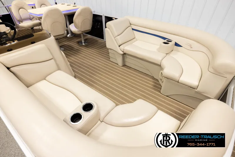 Slide: The Image of 2016 Bennington 24 SPDXDF pontoon boat interior with beige seating and wood-style flooring. - 9