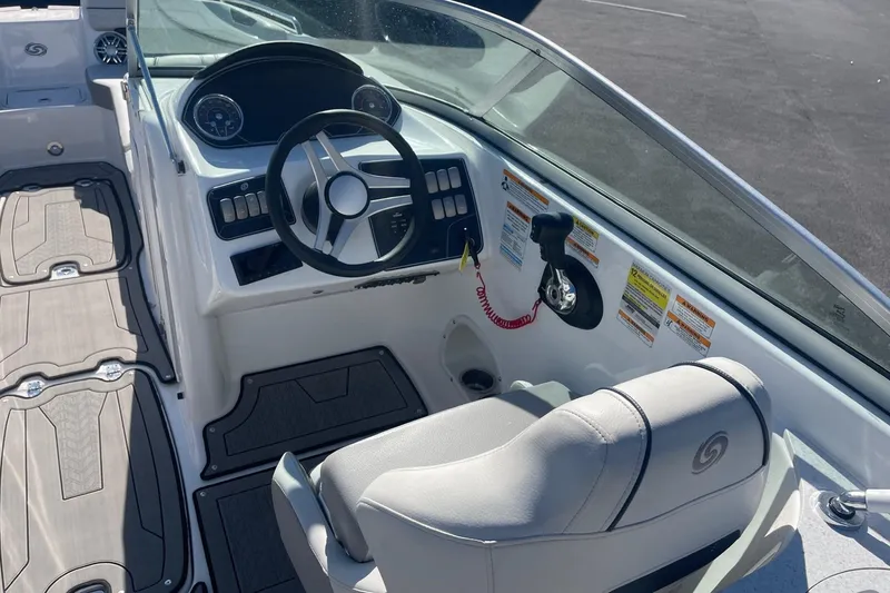 Slide: The Image of 2023 Hurricane SunDeck 2400 OB boat interior with steering wheel and seating. - 13