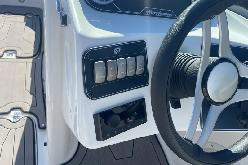 Slide: The Image of 2023 Hurricane SunDeck 2400 OB boat dashboard with steering wheel and control panel. - 16