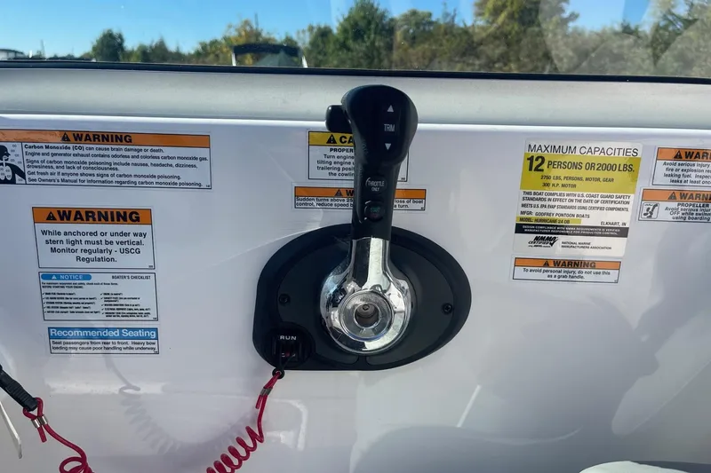 Slide: The Image of Control panel of 2023 Hurricane SunDeck 2400 OB with safety warnings and capacity details. - 19