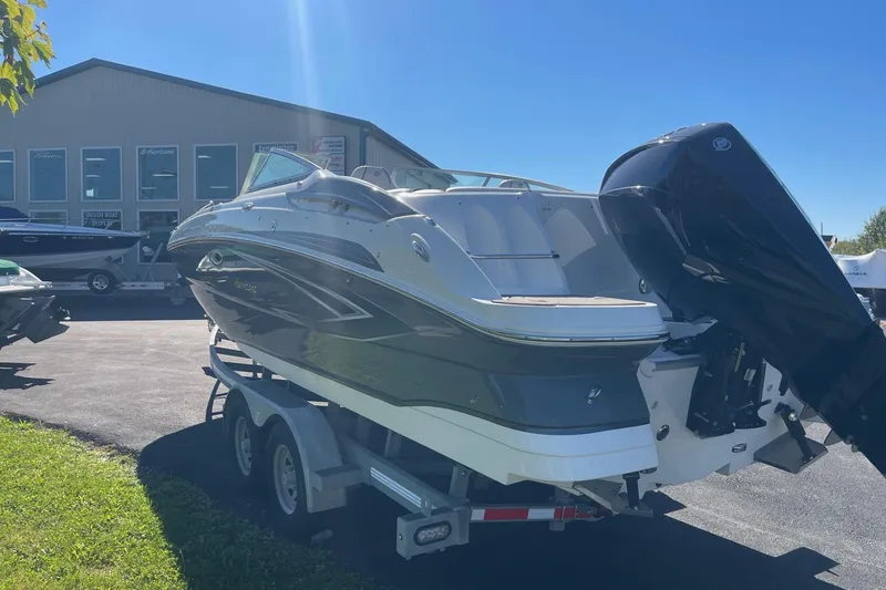 Slide: The Image of 2023 Hurricane SunDeck 2400 OB boat on trailer, parked outside dealership. - 2