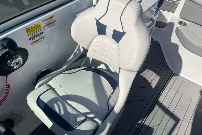 Slide: The Image of Captain's chair on 2023 Hurricane SunDeck 2400 OB boat, featuring sleek design and controls. - 21