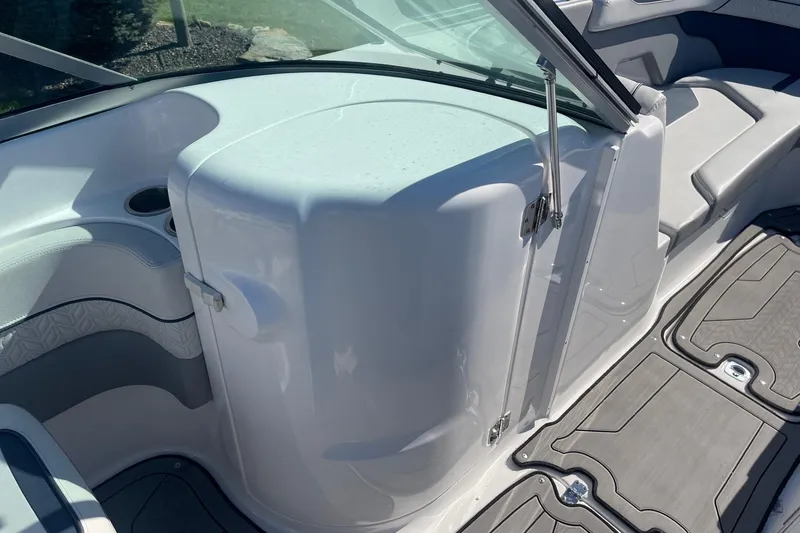 Slide: The Image of 2023 Hurricane SunDeck 2400 OB interior with seating and storage compartment. - 22