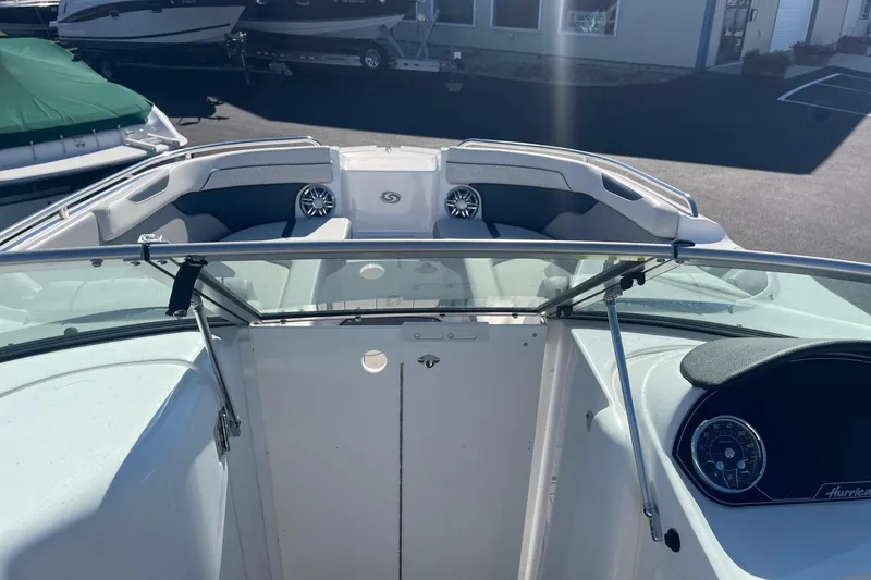 Slide: The Image of 2023 Hurricane SunDeck 2400 OB boat interior with seating and dashboard view. - 25