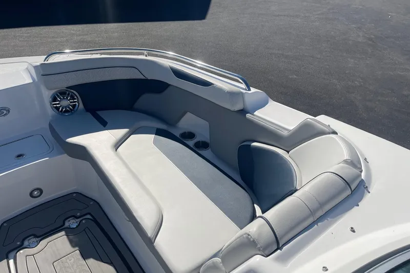 Slide: The Image of 2023 Hurricane SunDeck 2400 OB boat interior with cushioned seating and cup holders. - 27