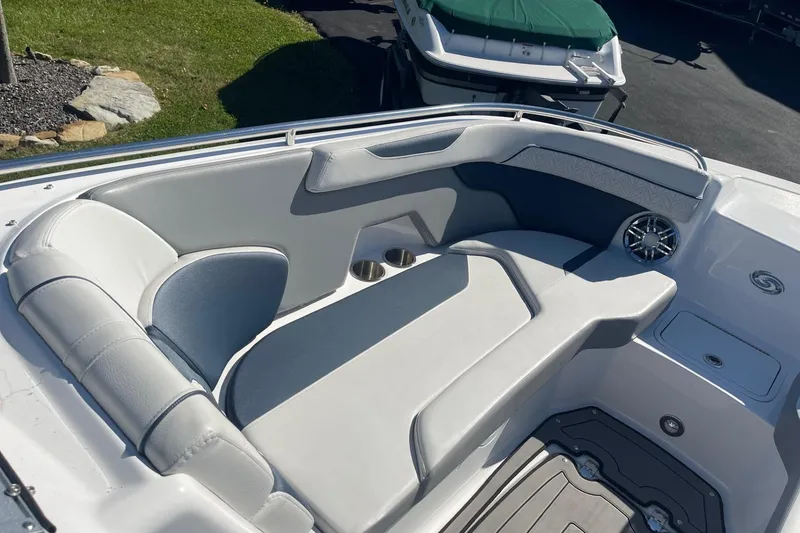 Slide: The Image of 2023 Hurricane SunDeck 2400 OB boat interior with cushioned seating and cup holders. - 28