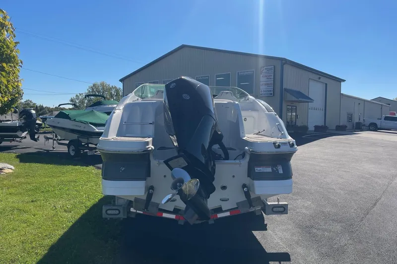 Slide: The Image of 2023 Hurricane SunDeck 2400 OB boat with outboard motor in a dealership lot. - 3