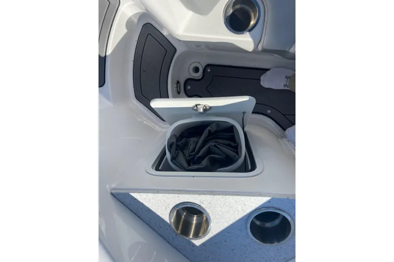 Slide: The Image of 2023 Hurricane SunDeck 2400 OB boat storage compartment with cup holders. - 36