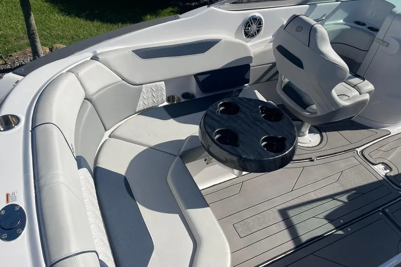 Slide: The Image of 2023 Hurricane SunDeck 2400 OB boat interior with seating and cup holders. - 7