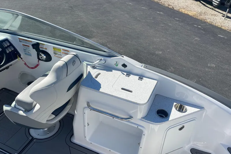 Slide: The Image of 2023 Hurricane SunDeck 2400 OB boat interior with helm seat and console details. - 8