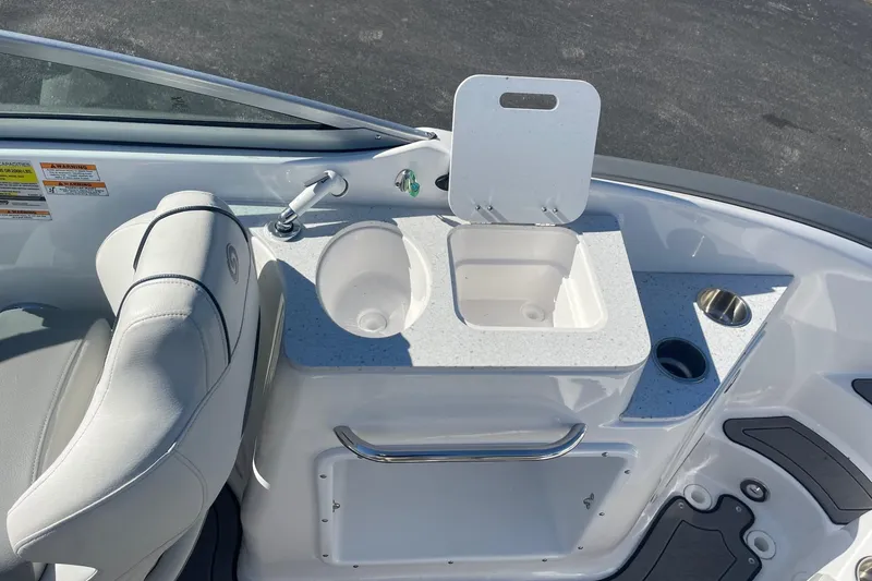 Slide: The Image of 2023 Hurricane SunDeck 2400 OB boat interior with sink and seating area. - 9
