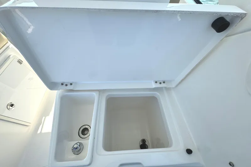 Slide: The Image of 2020 Pursuit DC 235 Dual Console boat with outboard motor on water. - 12