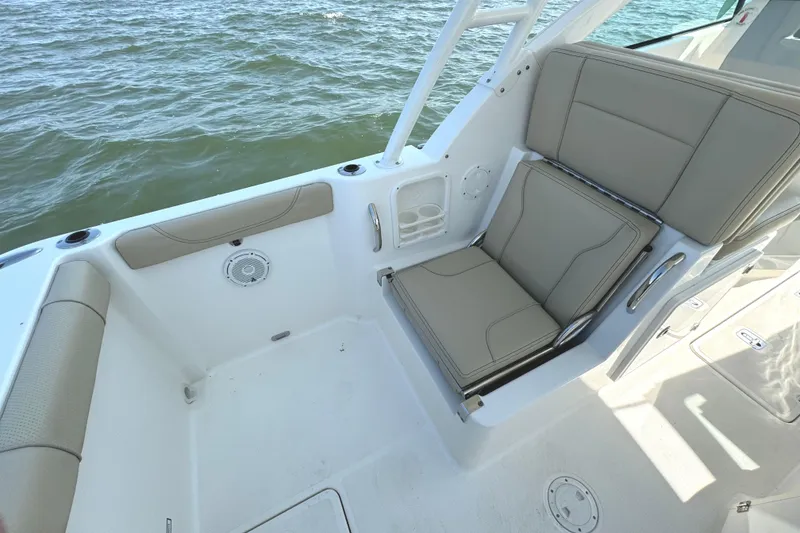 Slide: The Image of 2020 Pursuit DC 235 Dual Console boat interior with teak flooring, ocean view. - 13