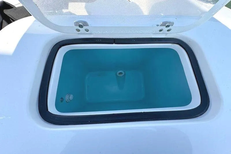 Slide: The Image of 2020 Pursuit DC 235 Dual Console boat with motor and seating, on water. - 16